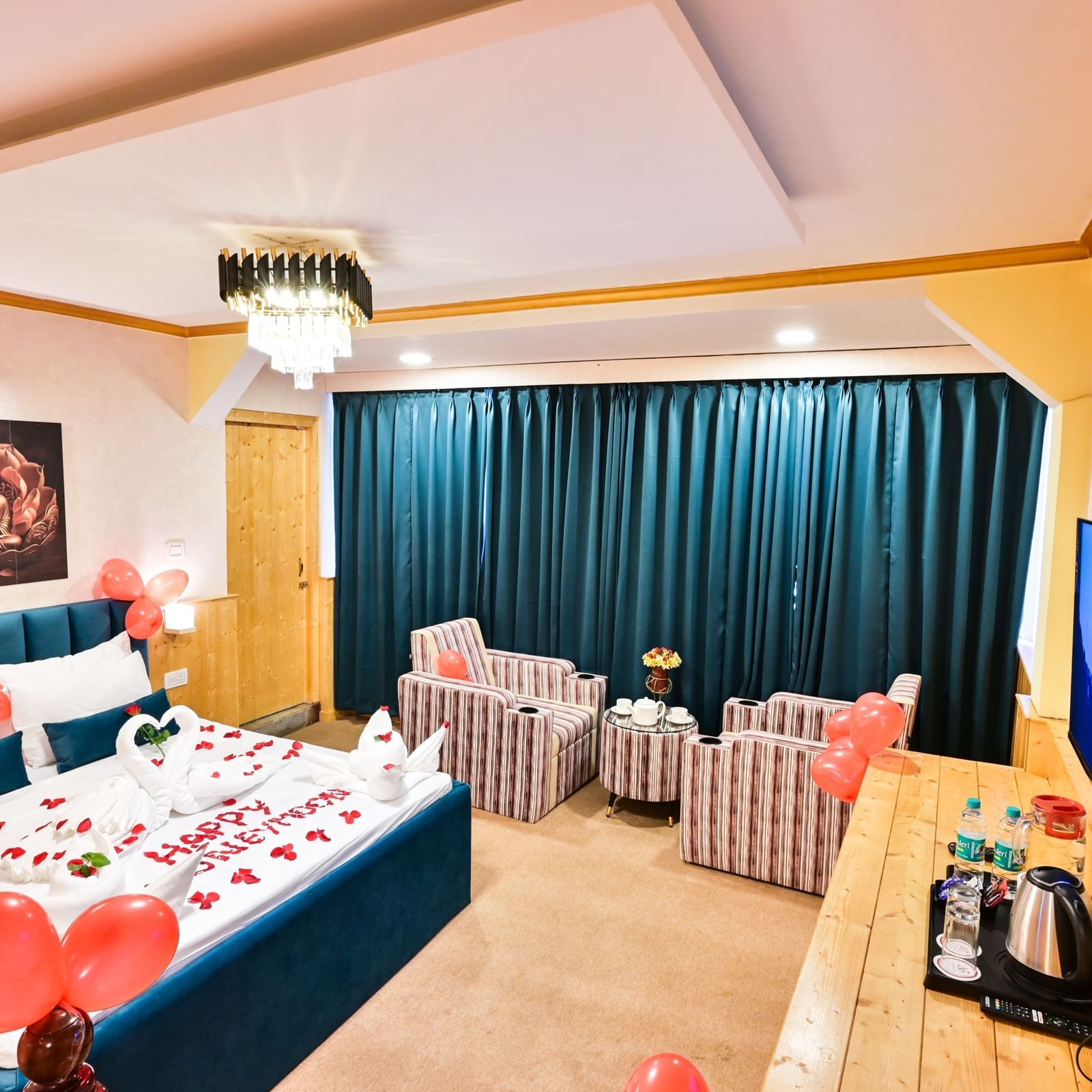 The suite is decorated with red heart balloons, rose petals, towels folded into shapes resembling cakes and swans for honeymoon celebrations at Avianna Seven Seas, Darjeeling5