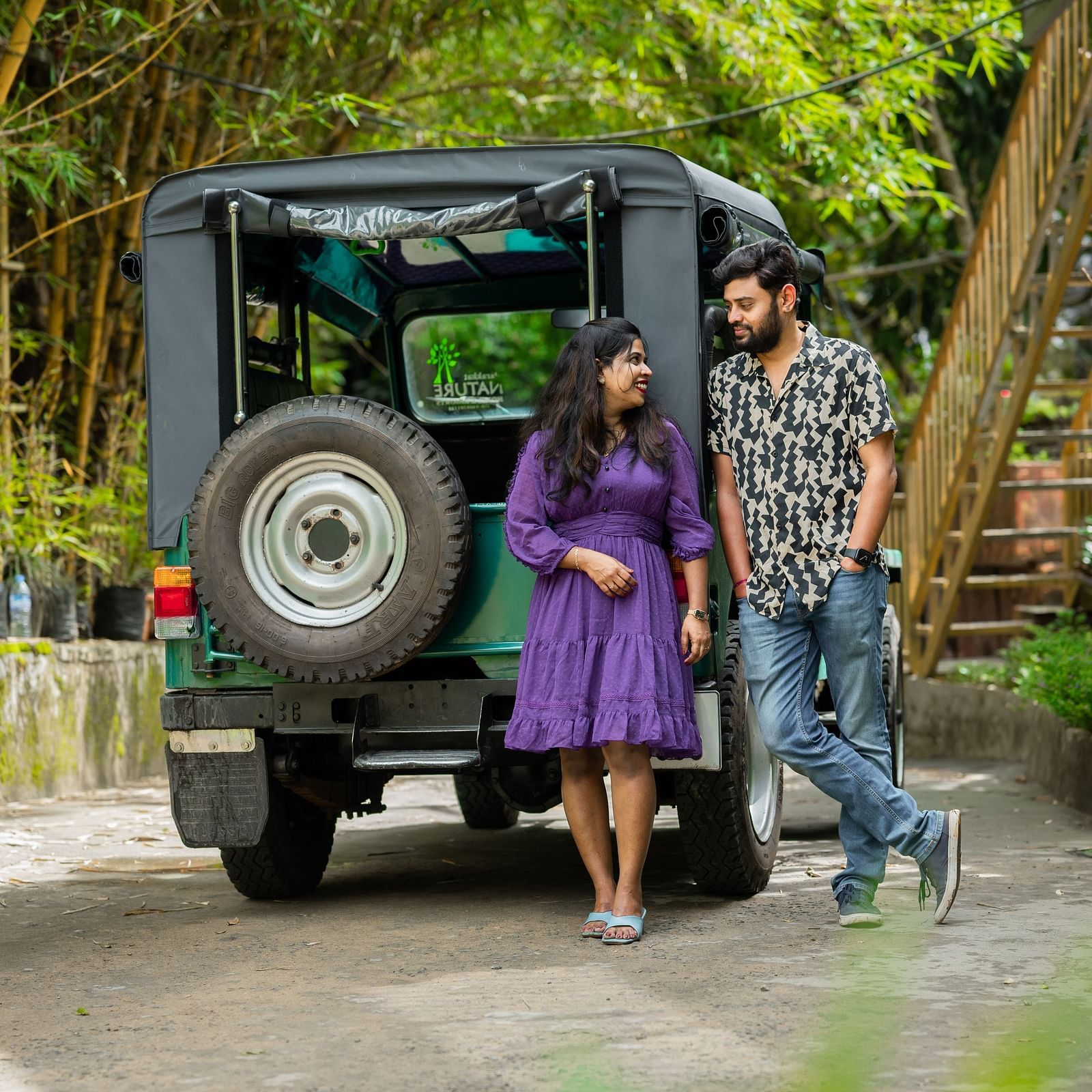 A couple standing in front of a jeep for photoshoot at Parakkat Nature Hotel & Resorts, Munnar 19