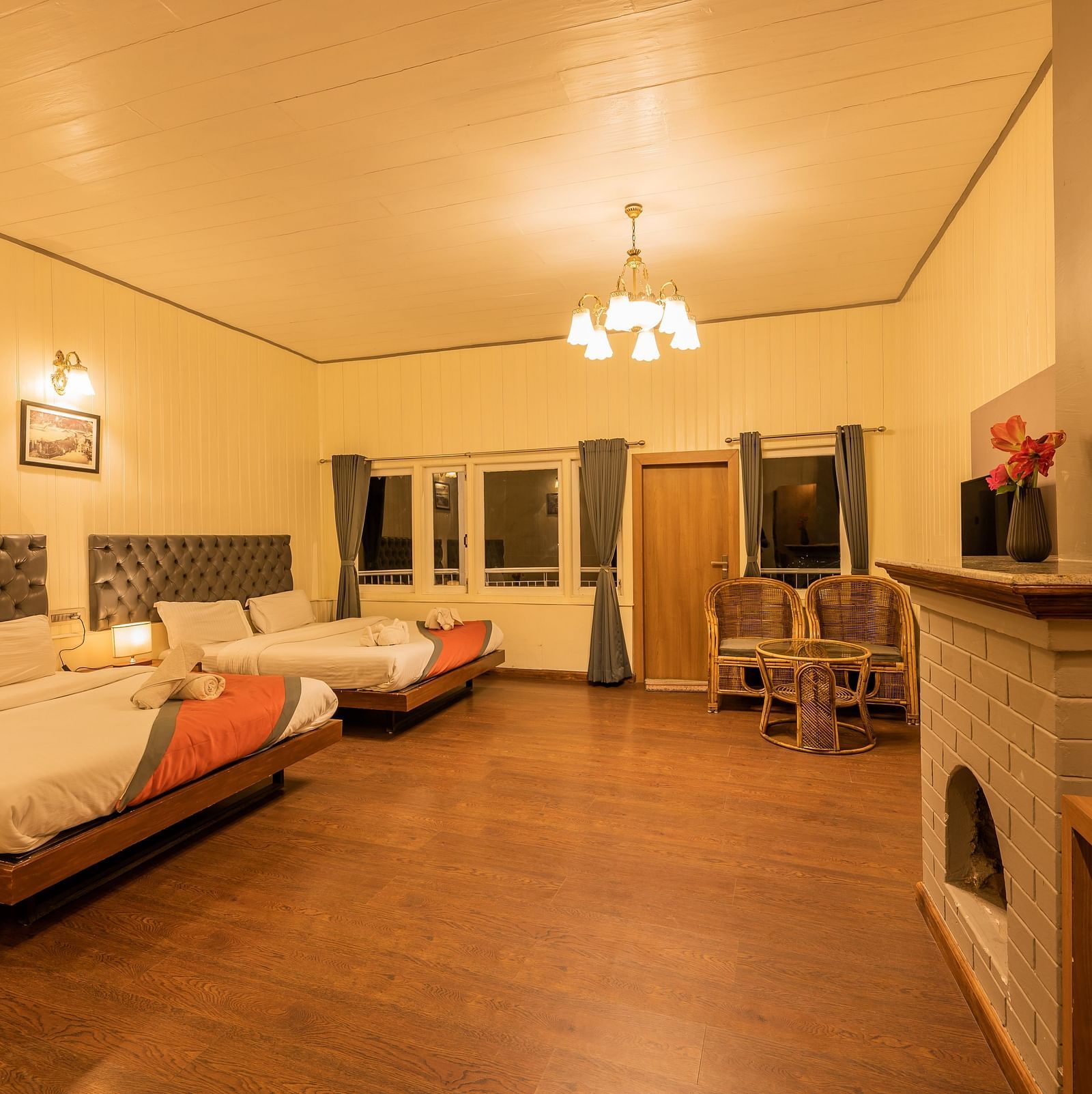 A spacious family room with 2 comfy beds, table, chimney at Arcadia Heritage Resort, Darjeeling