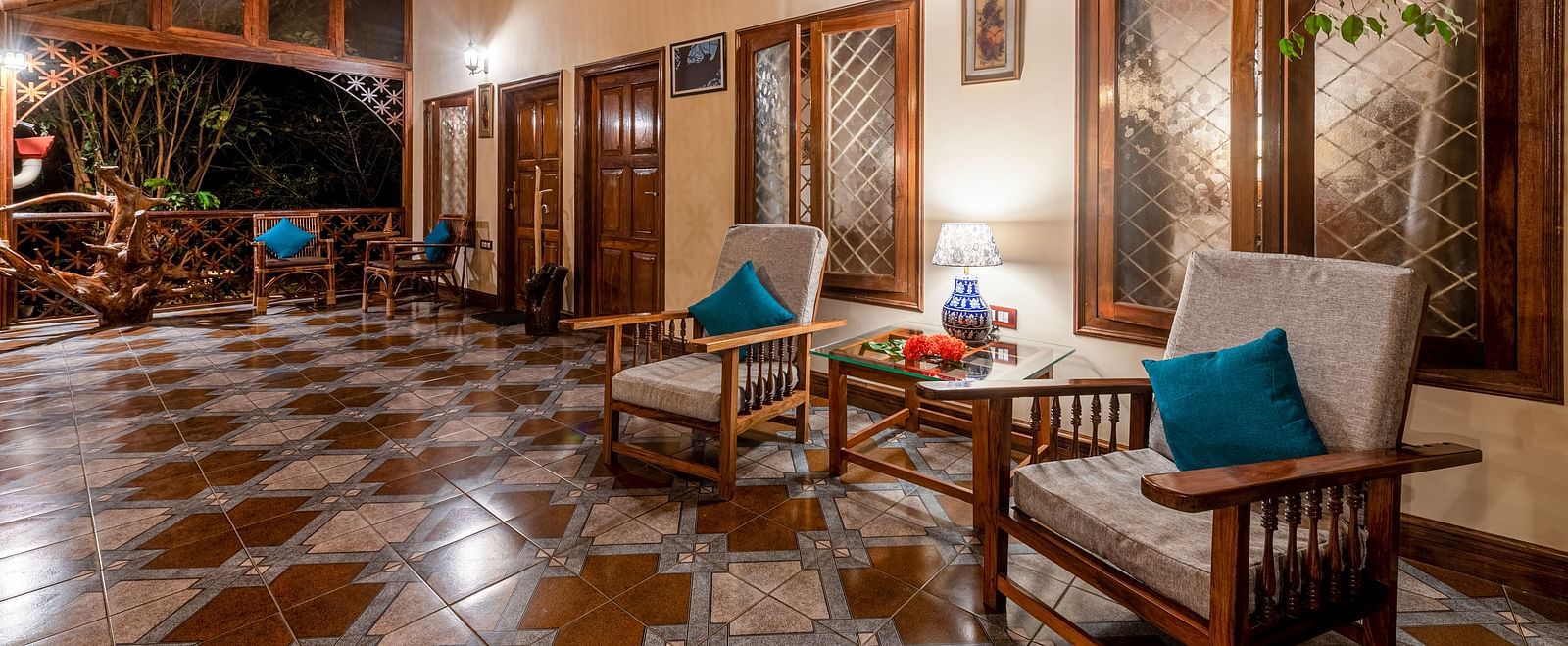 Long, well-lit corridor with wooden panelling and comfortable seating areas - BluSalzz Collection - Tranquil Resort, Wayanad