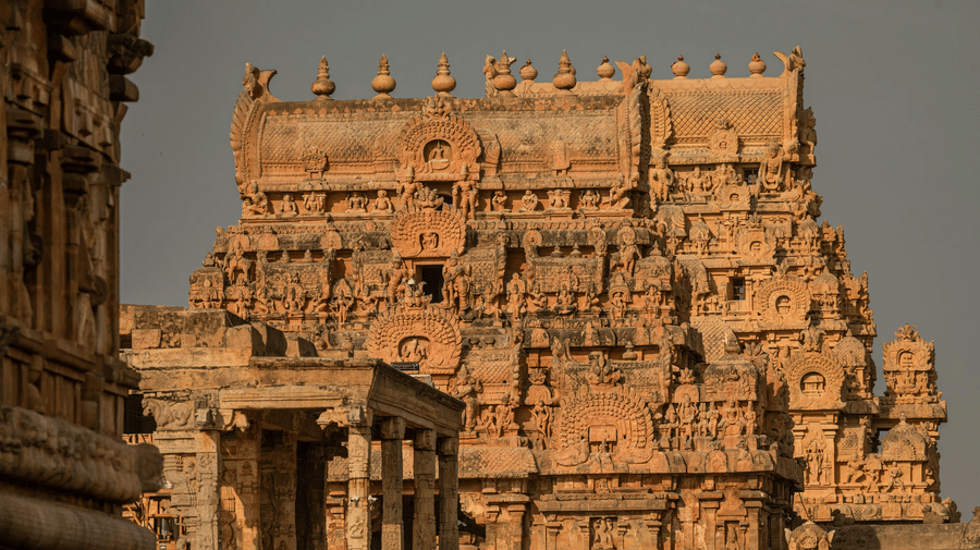 A close-up shot of the ornate stone tower of the Brihadisvara Temple in Thanjavur.