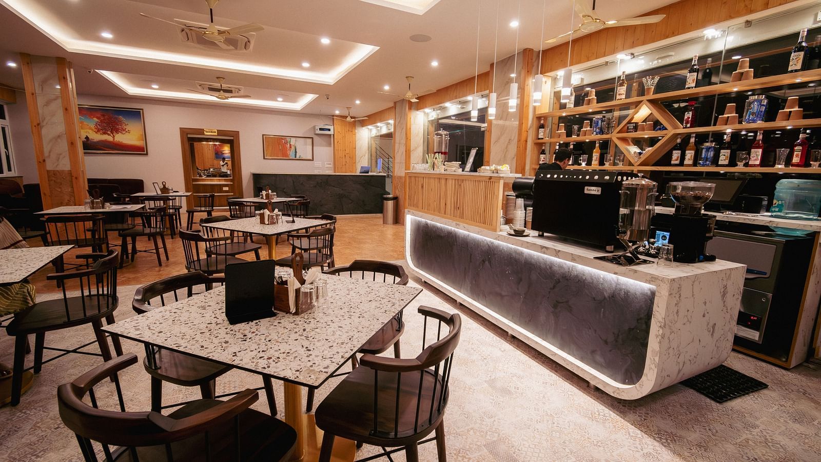 Image of the restaurant at The Tattva, Devprayag featuring fine dining setup and bar section.