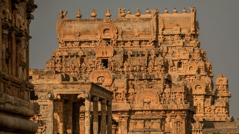 A close-up shot of the ornate stone tower of the Brihadisvara Temple in Thanjavur.