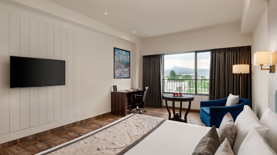 Superior Room at Voyage Milestone Hotel and Banquet with twin beds and wall-mounted TV.
