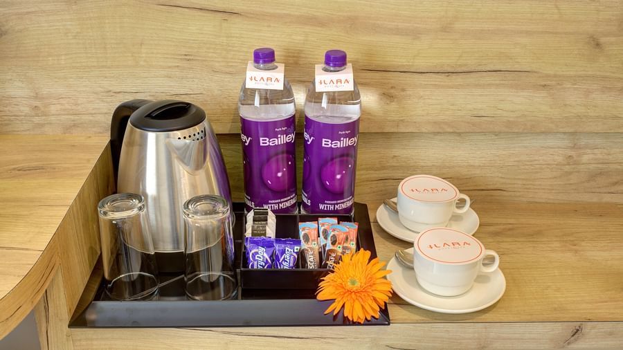 Close up shot of a kettle kept long with packaged drinking water and coffee cups at the Junior Suite at Ilara Hotels & Spa, Tada.