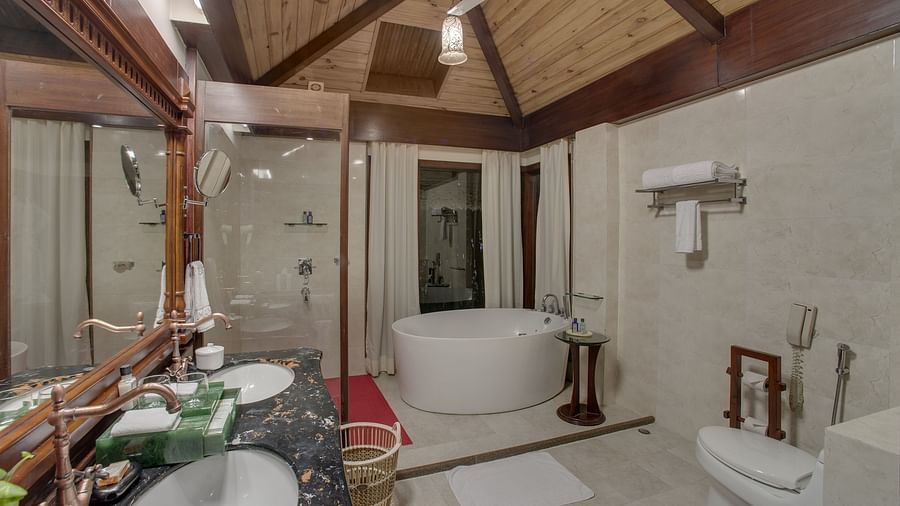 the bathtub and the wash basin area of the bathroom - Mayfair Spa Resort & Casino Gangtok 