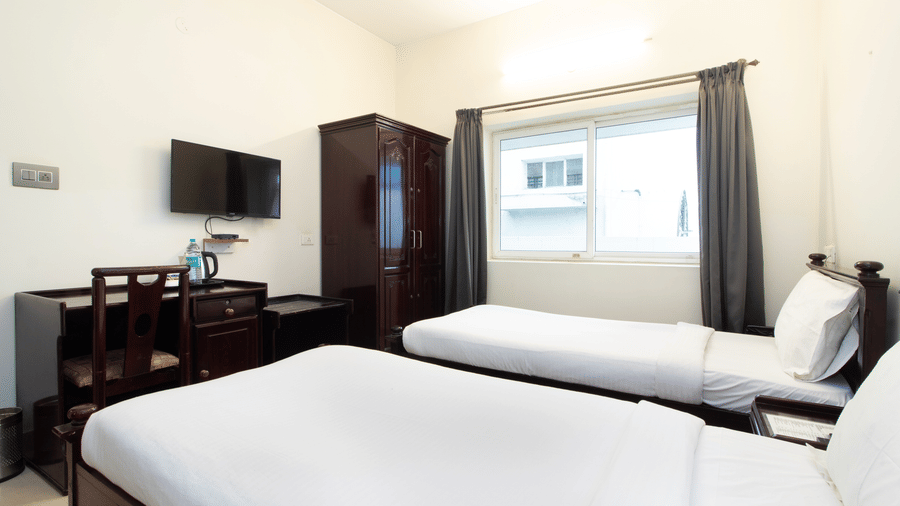 hotel-room-double-bed-sofa-curtains-wardrobe