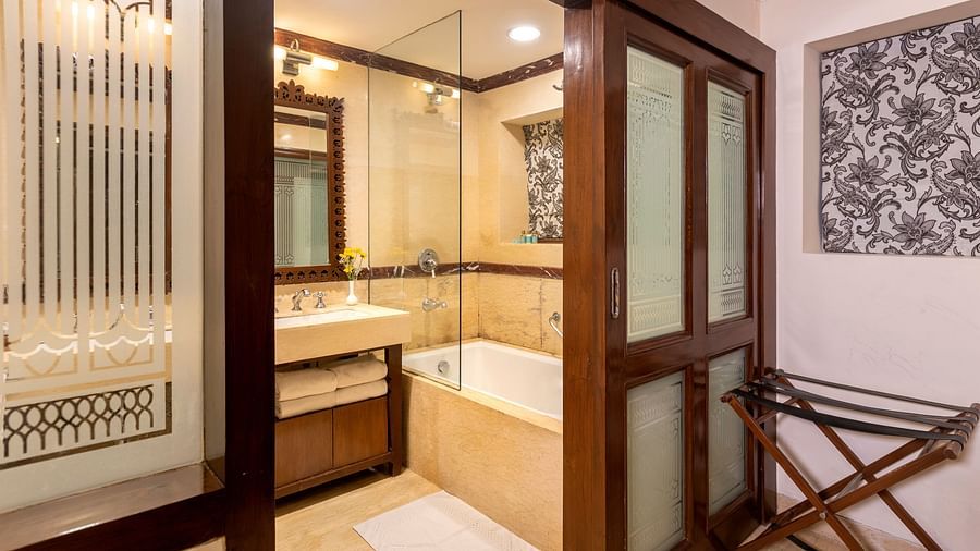 view of the bathroom from its entrance with a bathtub at Club rooms at The Claridges Nabha Residence