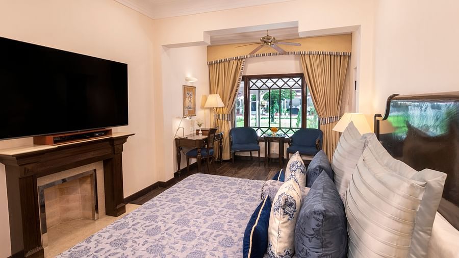 a side angle view of the Claridges room with a huge TV installed at the The Claridges Nabha Residence