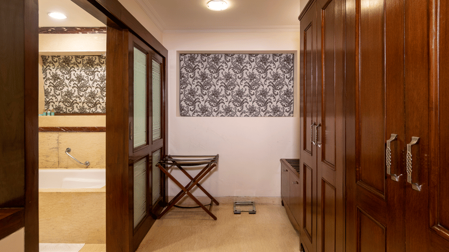 image of the closet and the bathroom entrance of the Club room at The Claridges Nabha Residence