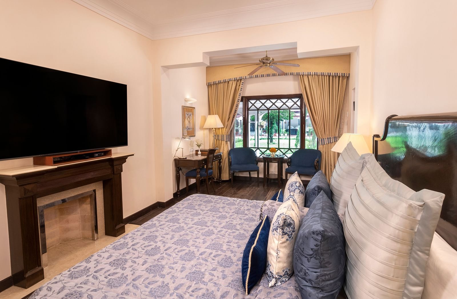 a side angle view of the Claridges room with a huge TV installed at the The Claridges Nabha Residence