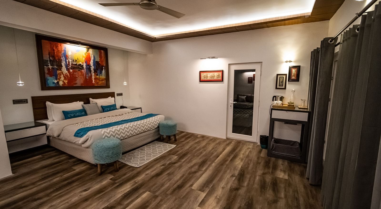 corner view image of the bedroom in the pent house featuring a double bed with modern interiors - The Tattva Boutique Resort