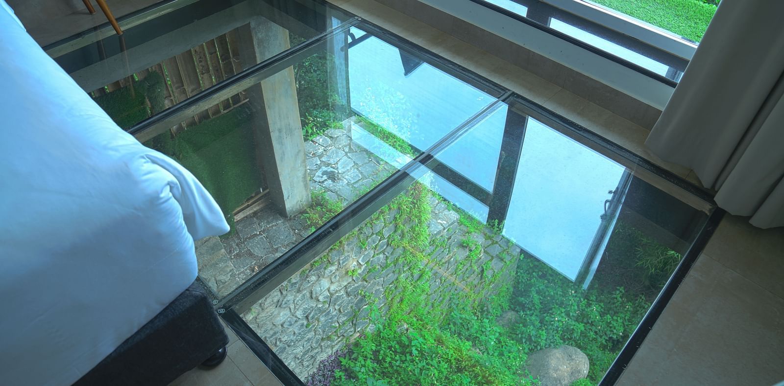 An image of a panorama view room showcasing glass floor for the serene view - Great Trails Yercaud by GRT Hotels