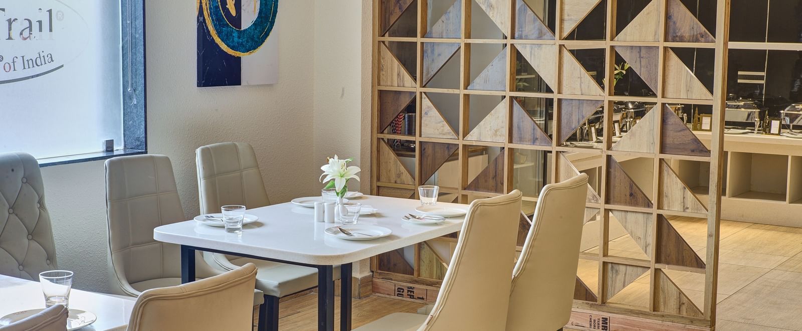A close up shot of a dining table with well arranged cutlery and new glassware on it at the Moti Mahal Restaurant at Ilara Hotels & Spa, Tada.