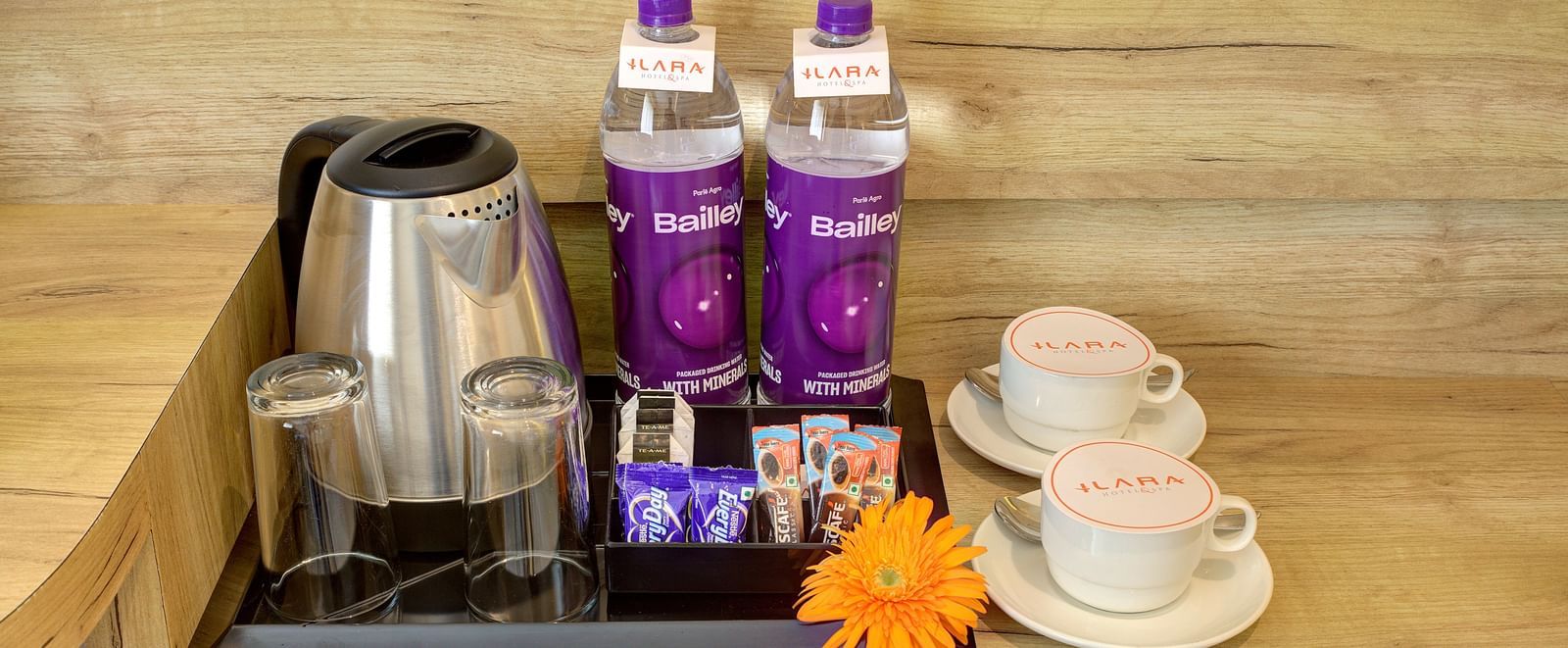 Close up shot of a kettle kept long with packaged drinking water and coffee cups at the Junior Suite at Ilara Hotels & Spa, Tada.