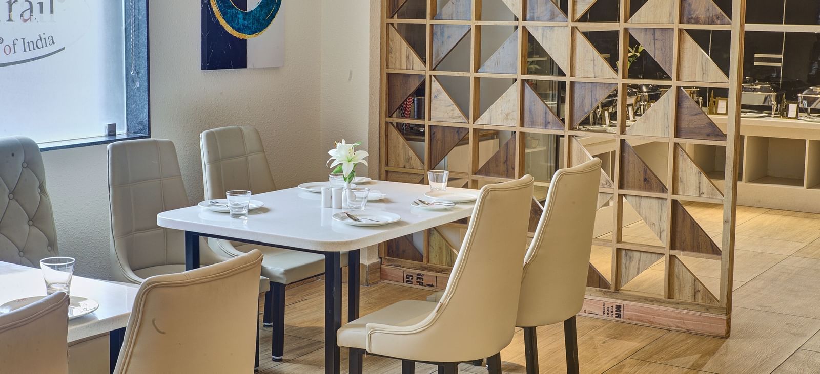 A close up shot of a dining table with well arranged cutlery and new glassware on it at the Moti Mahal Restaurant at Ilara Hotels & Spa, Tada.