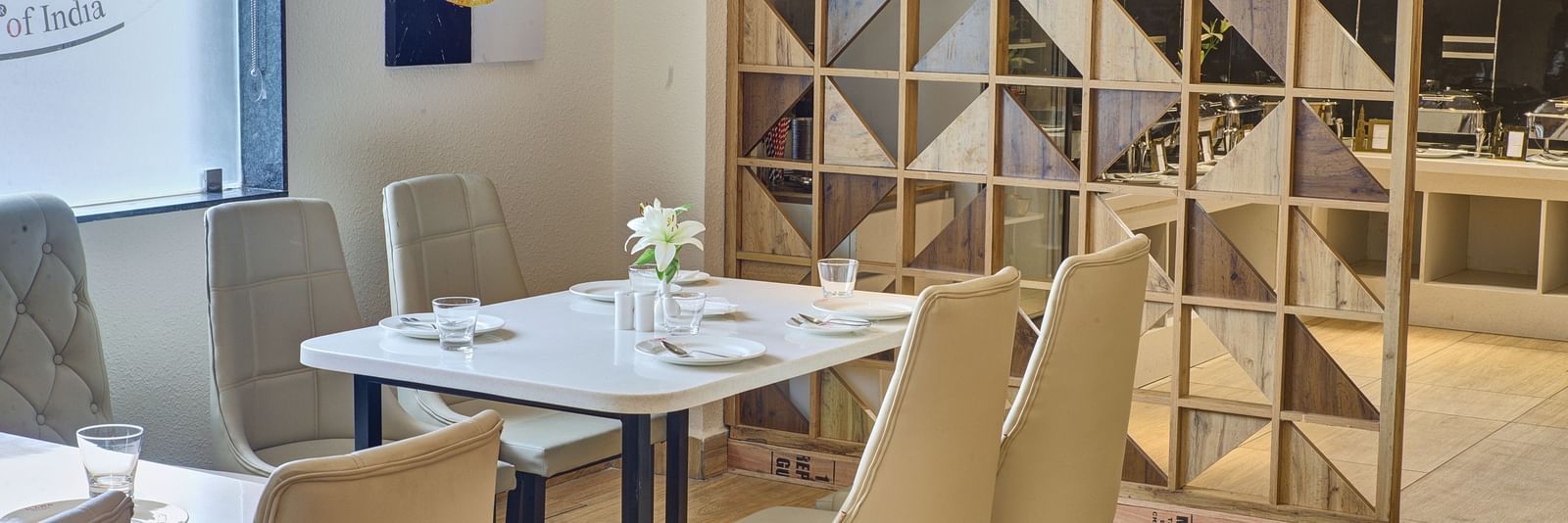 A close up shot of a dining table with well arranged cutlery and new glassware on it at the Moti Mahal Restaurant at Ilara Hotels & Spa, Tada.