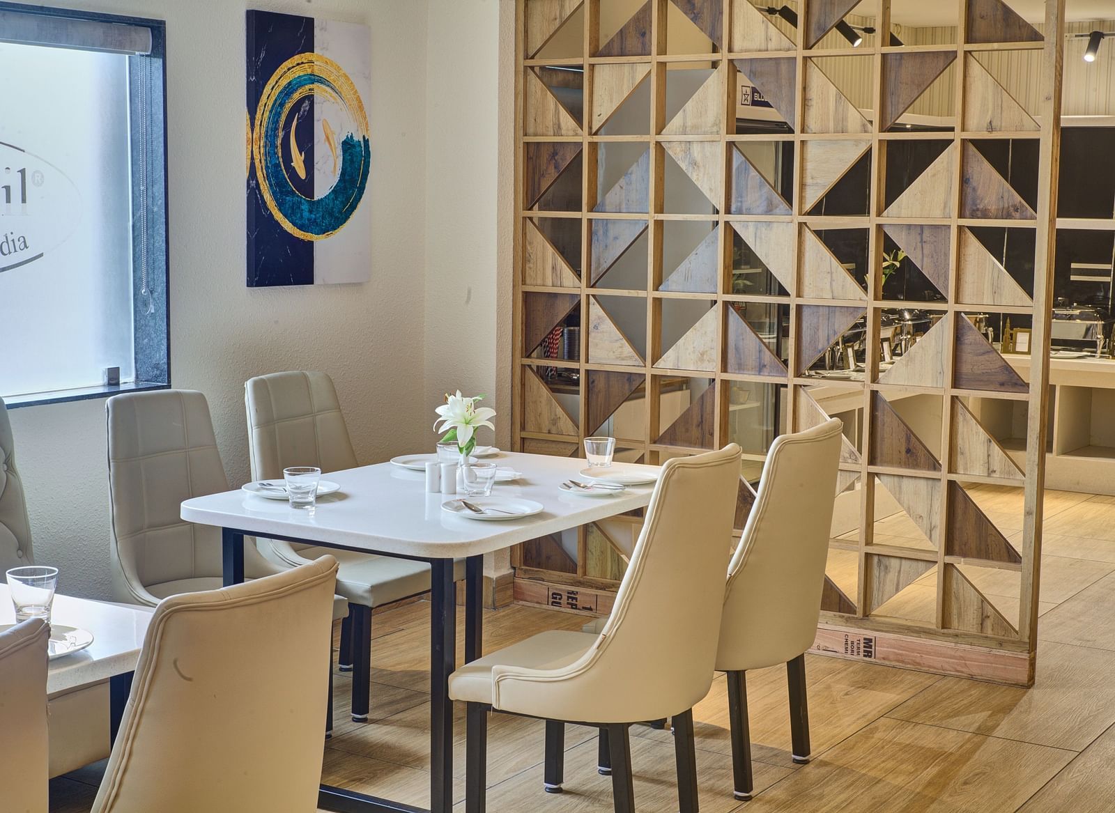 A close up shot of a dining table with well arranged cutlery and new glassware on it at the Moti Mahal Restaurant at Ilara Hotels & Spa, Tada.