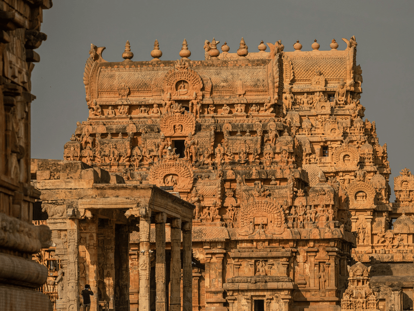 A close-up of the ornate stone tower of the Brihadisvara Temple in Thanjavur with it's carvings on the roof. The weather in Thanjavur tropical, and winter months are suited for travellers.