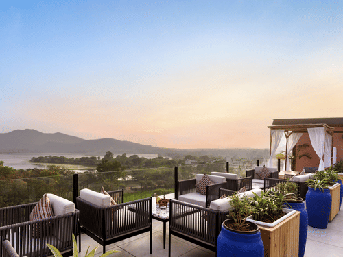 The terrace bathed in soft lights, highlighting comfortable seating and panoramic views.