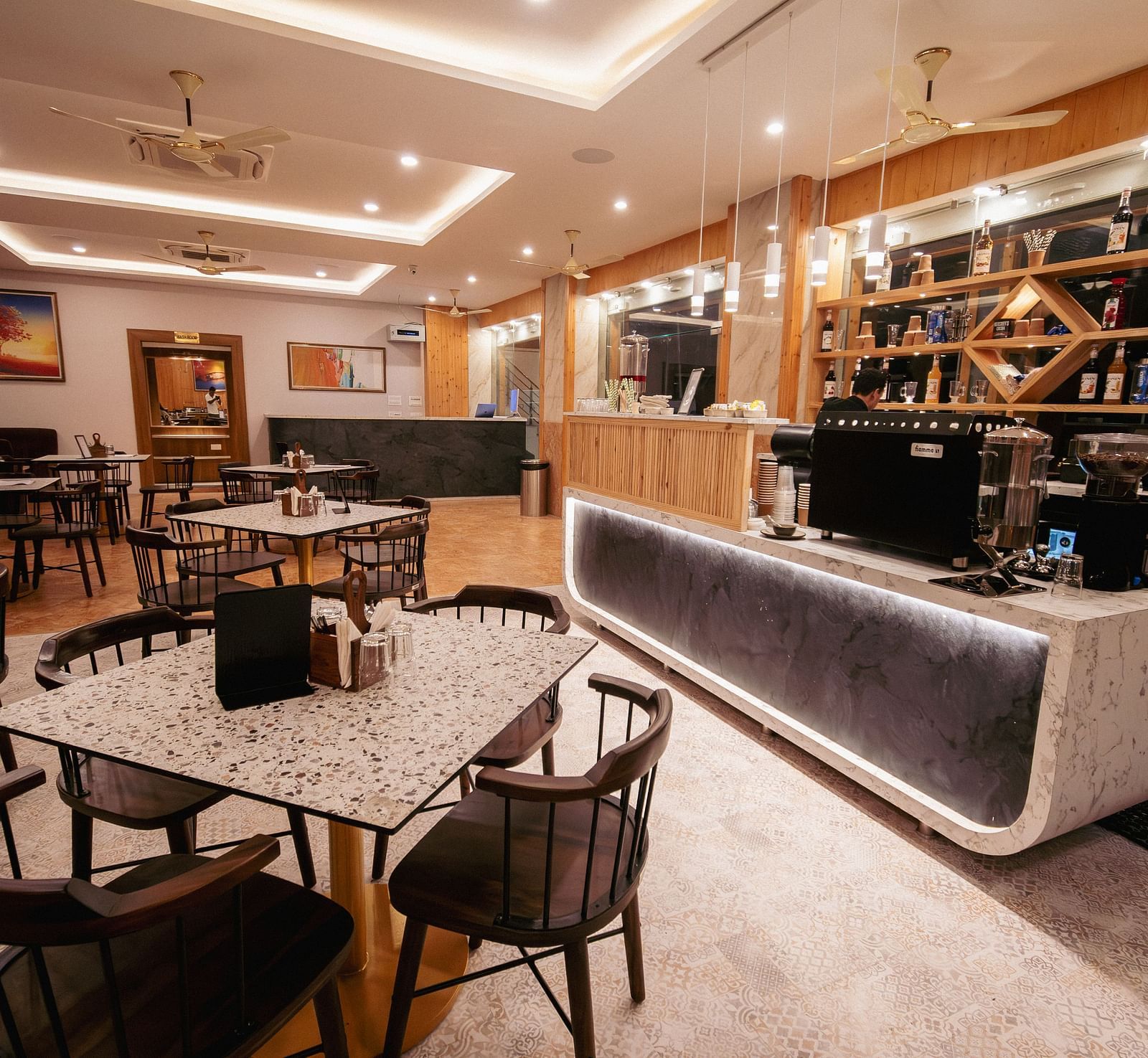 An overview of a restaurant at The Tattva, Devprayag featuring fine dining setup and bar section. - Restaurants in Devprayag