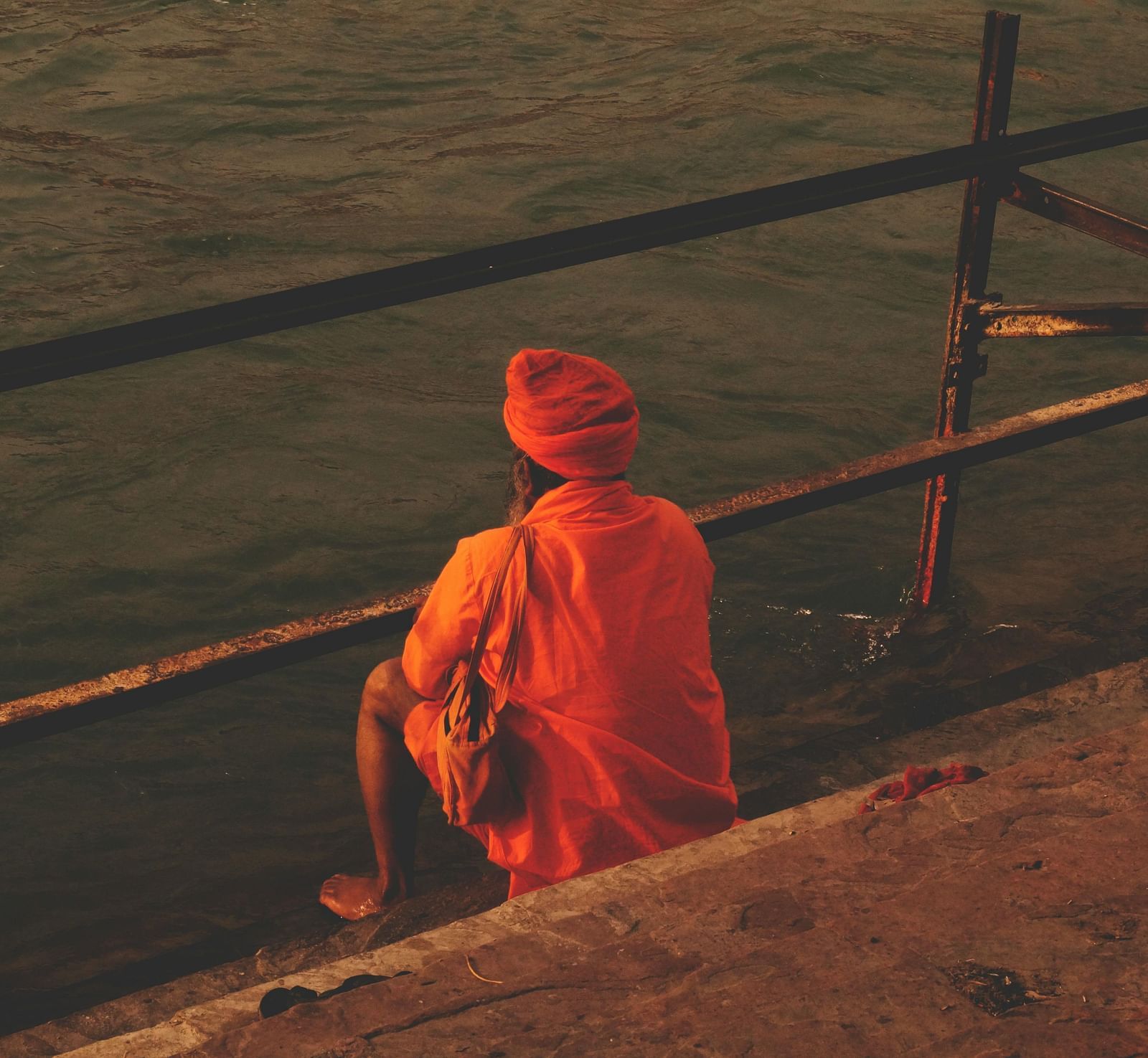 A monk meditating by the riverside