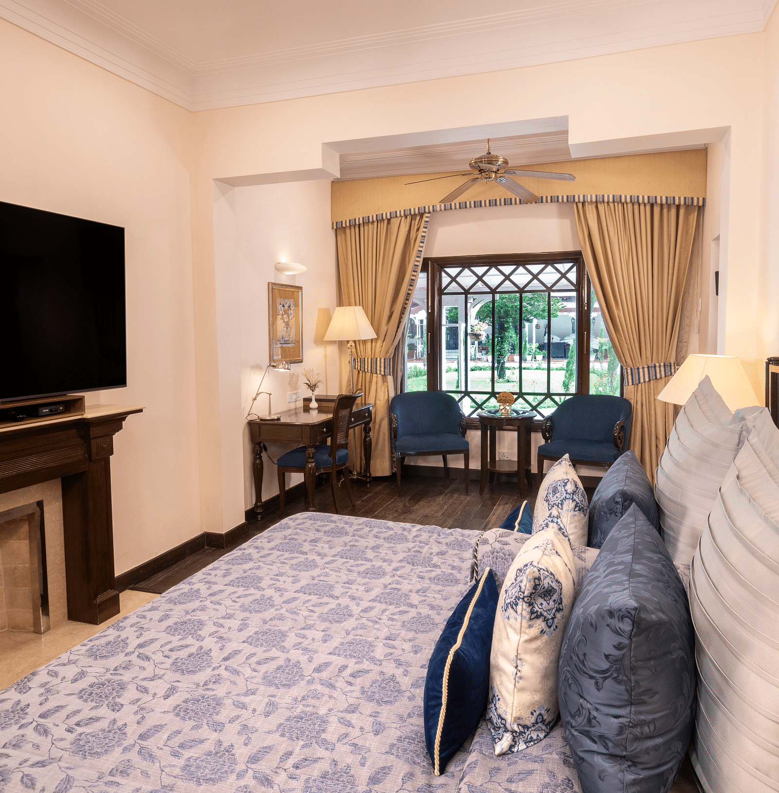a side angle view of the Claridges room with a huge TV installed at the The Claridges Nabha Residence