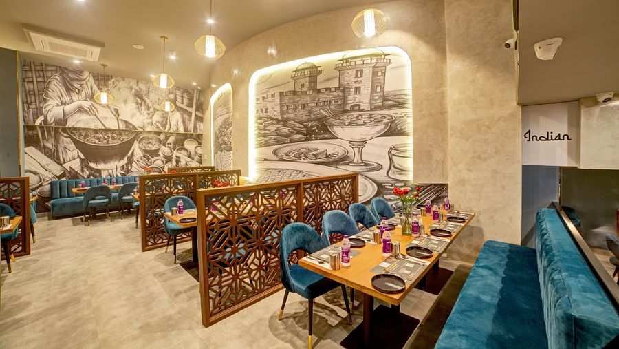 Elegant dining booths with monochrome wall art at Ilara Hotels & Spa, OMR, Chennai