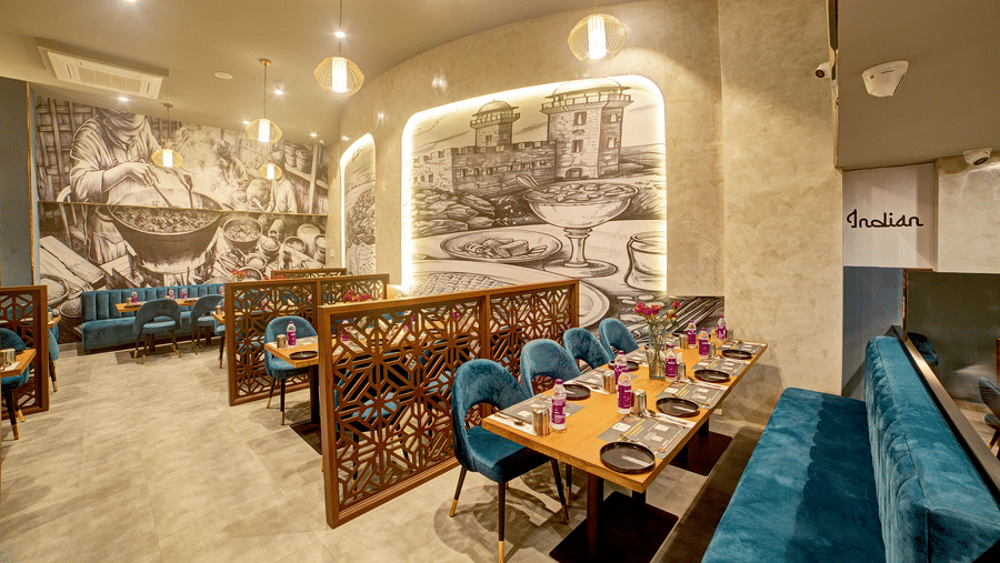 Elegant dining booths with monochrome wall art at Ilara Hotels & Spa, OMR, Chennai