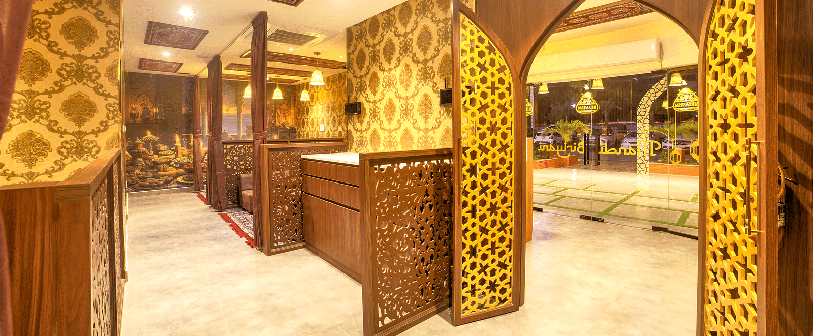 Decorative corridor with arches leading to intimate dining booths at Ilara Hotels & Spa, OMR, Chennai
