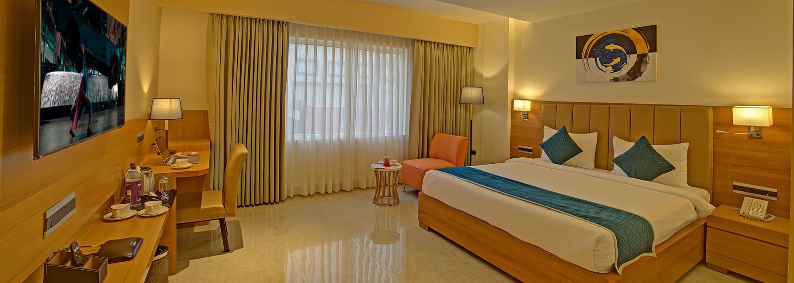 Full view shot of the Signature Suite with a back lit false ceiling above the above the double bed at Ilara Hotels & Spa, Tada.
