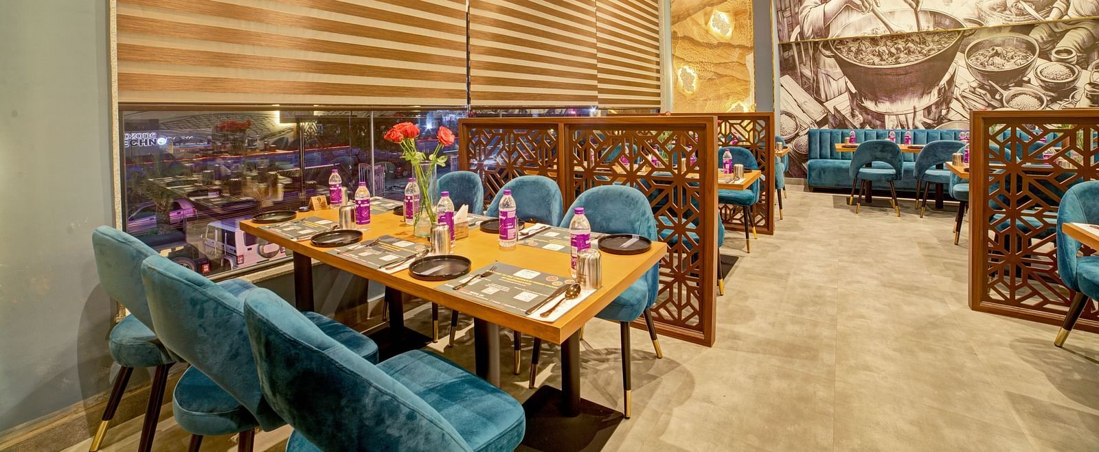 Chic restaurant interiors with wooden accents and floral centrepieces at Ilara Hotels & Spa, OMR, Chennai