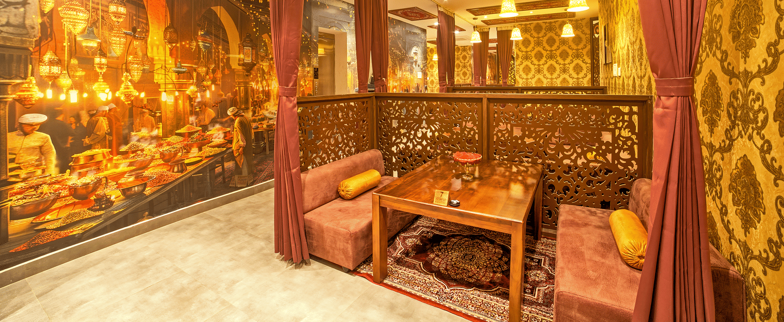 Elegant dining setup with traditional Indian mural at Ilara Hotels & Spa, OMR, Chennai