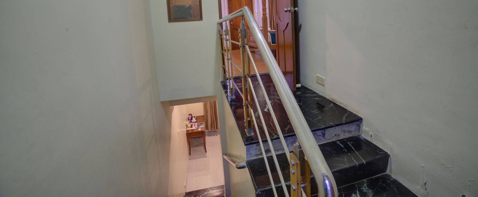 View of stairwell and corridor from the upper level of the hotel at Ilara Hotels & Spa, OMR, Chennai