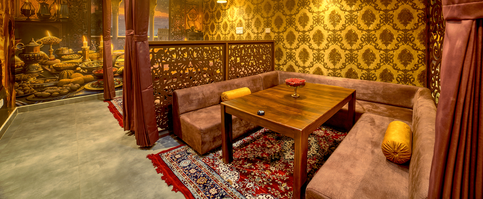 Cosy booth dining with regal interiors and rich curtains at Ilara Hotels & Spa, OMR, Chennai