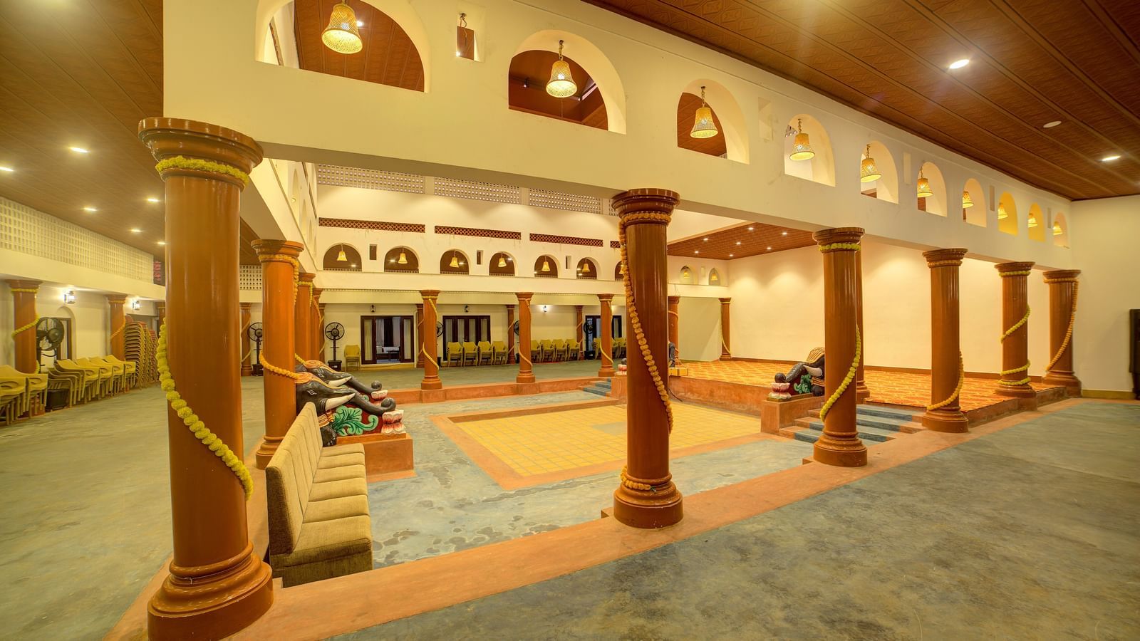 Traditional entrance with pillars and archways illuminated by warm lighting at Kailash Conventions ECR.