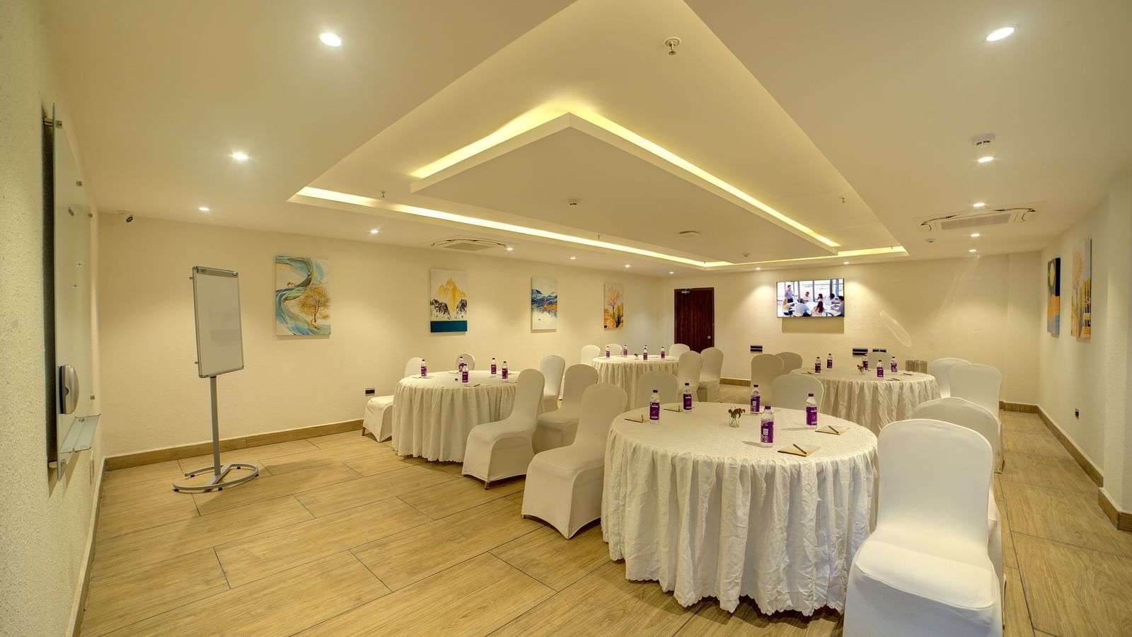 Corner view of the banquet hall with all the chairs facing towards the empty area in the foreground at Ilara Hotels & Spa, Tada.
