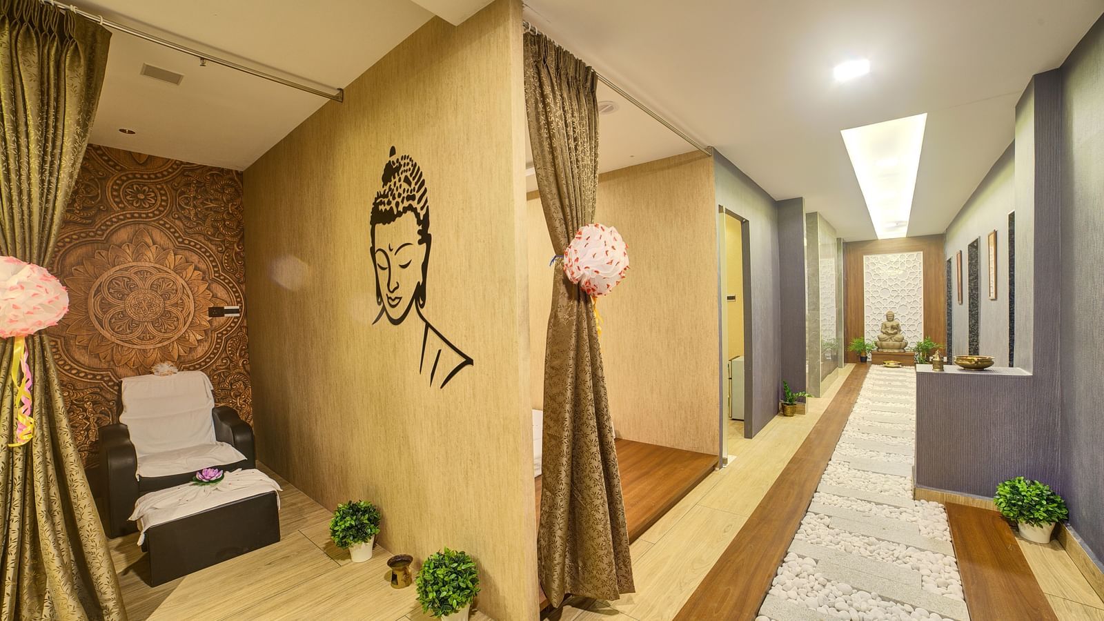A wide angle shot of the Hasta Spa at Ilara Hotels & Spa, Tada featuring a brightly lit corridor.