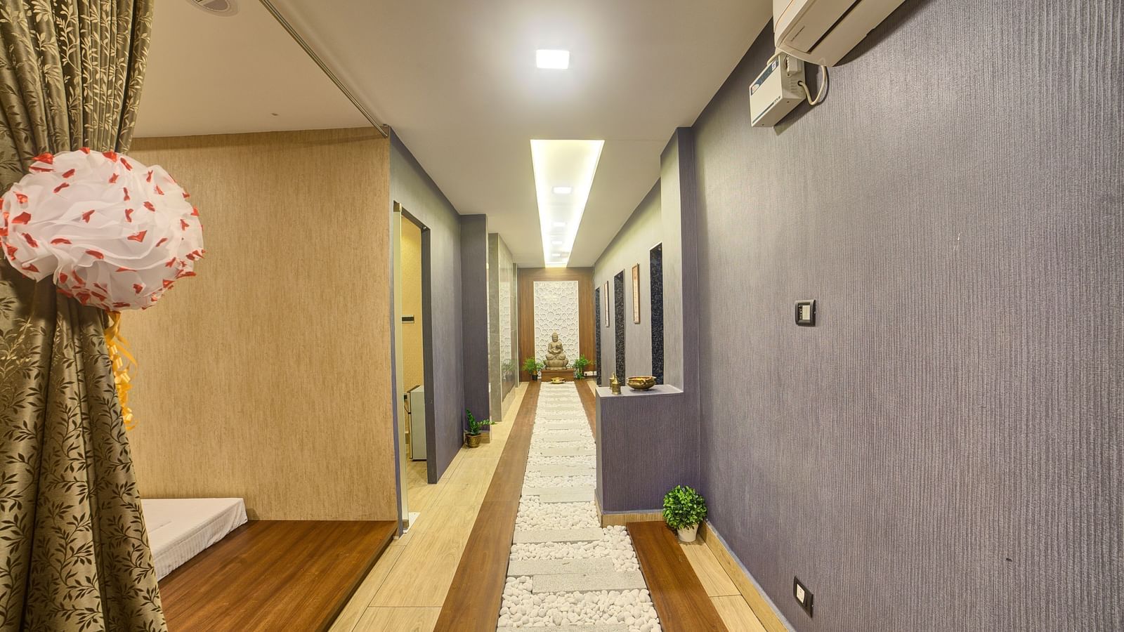 The corridor at the Hasta Spa with grey coloured wall in the side at Ilara Hotels & Spa, Tada.