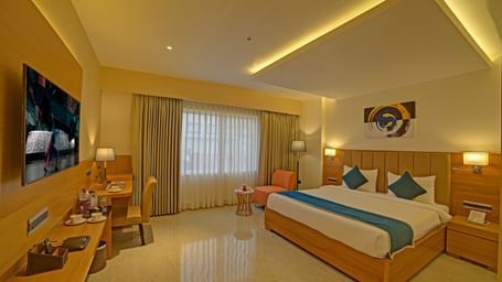 Full view shot of the Signature Suite with a back lit false ceiling above the above the double bed at Ilara Hotels & Spa, Tada.