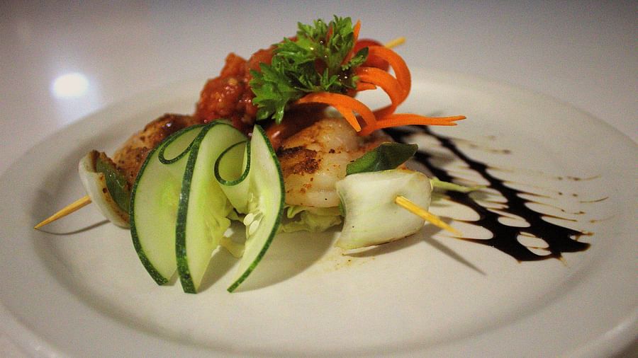 Grilled shrimp on a white plate with sliced cucumber and balsamic glaze - Hotel 39, Jamaica