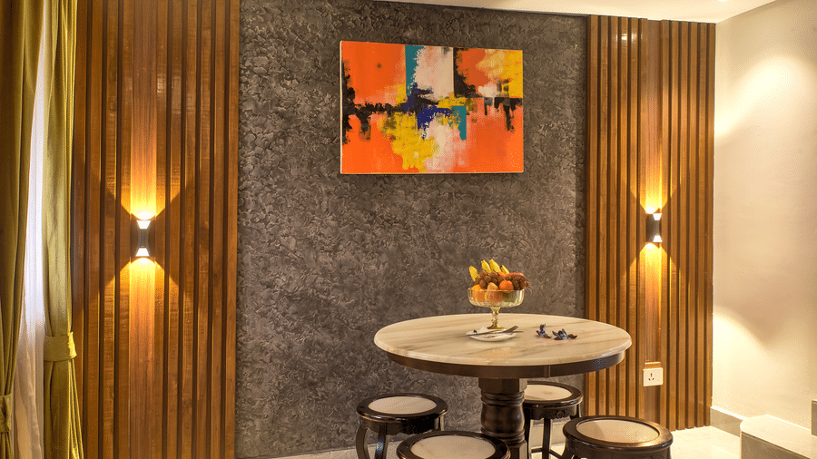 Compact dining nook with vibrant artwork and modern lighting at Ilara Hotels & Spa, OMR, Chennai