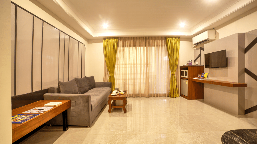 Spacious suite with large sectional sofa and extended seating area at Ilara Hotels & Spa, OMR, Chennai