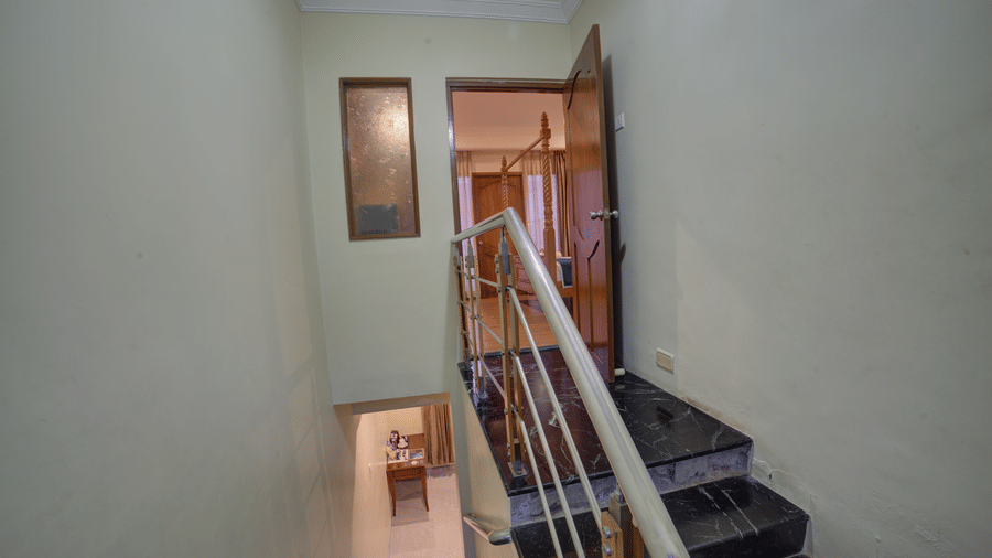 View of stairwell and corridor from the upper level of the hotel at Ilara Hotels & Spa, OMR, Chennai