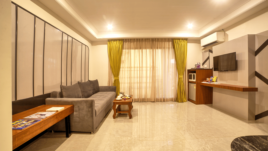 Spacious suite with large sectional sofa and extended seating area at Ilara Hotels & Spa, OMR, Chennai