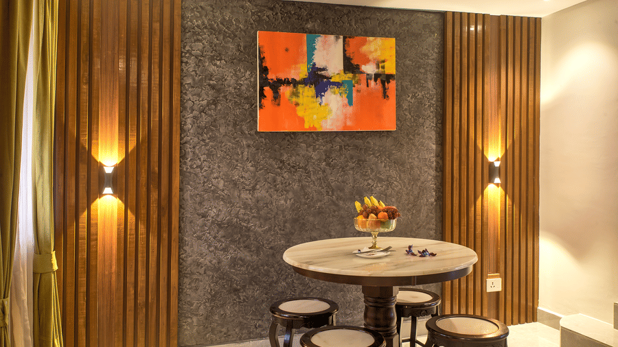 Compact dining nook with vibrant artwork and modern lighting at Ilara Hotels & Spa, OMR, Chennai