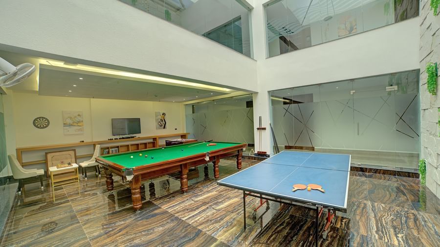 A billiard table along with a table tennis setup in the gaming area at Ilara Hotels & Spa, Tada.