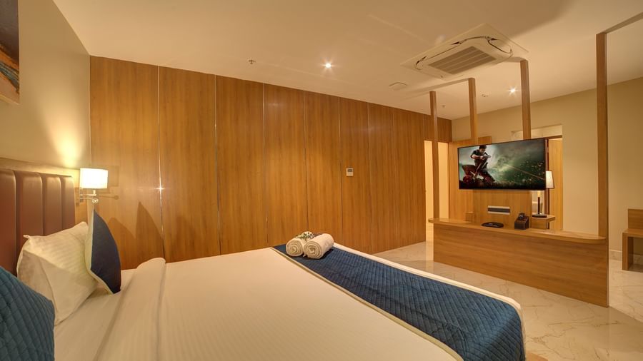 Corner view shot of the bedroom of the Executive Suite featuring a double bed overlooking a wall mounted television at Ilara Hotels & Spa, Tada.