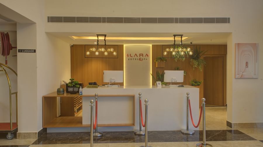Front view shot of the front desk with two desktops on the table at Ilara Hotels & Spa, Tada.
