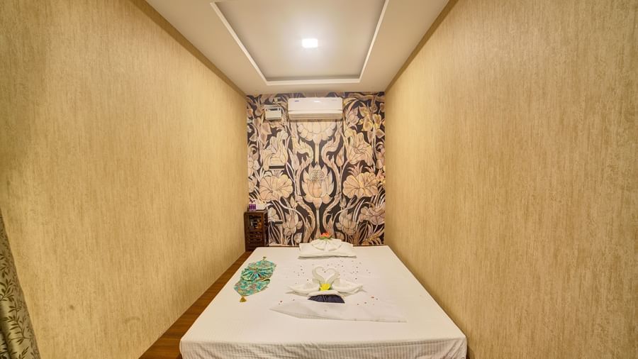 A double bed mattress with white bed sheet spread over it at Hasta Spa at Ilara Hotels & Spa, Tada.